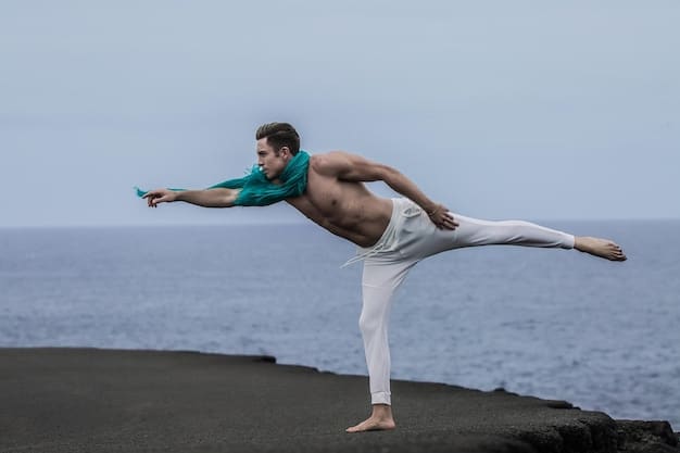 A male athlete performing a warrior II yoga pose, demonstrating strength and balance. He is focused and determined, showcasing the mental discipline aspects of yoga. The background is a gym or training facility.