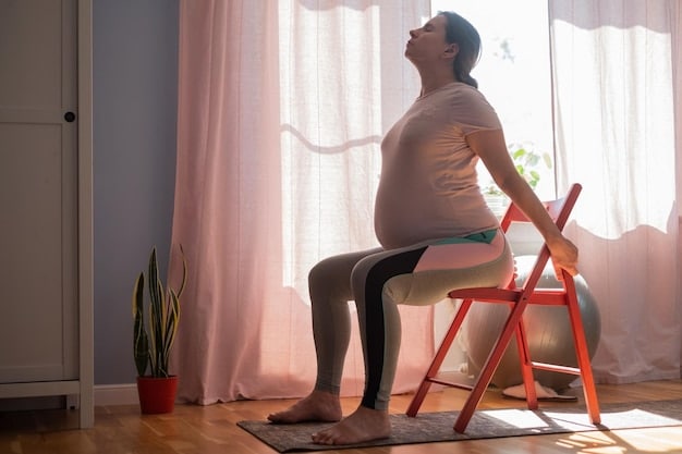 A pregnant woman in the Warrior II pose, demonstrating proper alignment and using a chair for support.