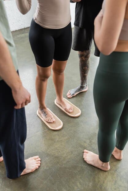 A close-up of hands adjusting a student's posture in a yoga class, showcasing the personalized attention and focus on alignment. The hands are gentle and supportive, creating a sense of trust and guidance.