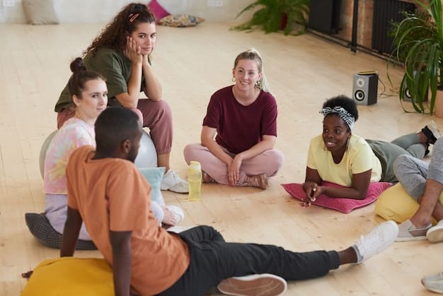 A group of yoga teacher trainees sitting in a circle, engaged in a deep discussion. Their faces reflect a mix of concentration and excitement, highlighting the collaborative learning environment of YTT.
