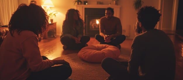 A group of employees participating in a guided meditation session in a quiet, dimly lit room. They are sitting comfortably on cushions, with their eyes closed and hands resting gently on their knees. The atmosphere is serene with soft lighting.
