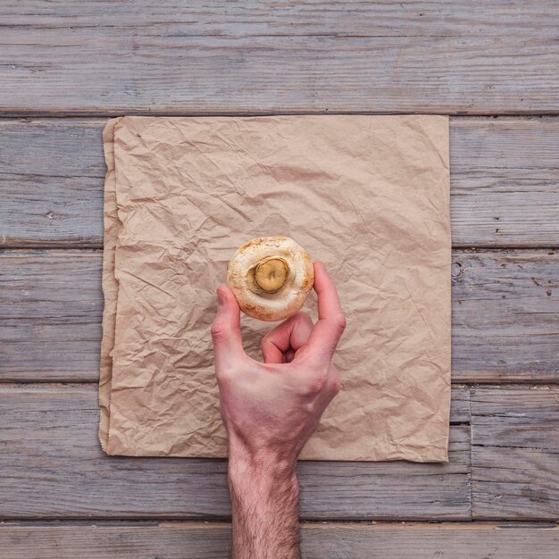 A close-up shot of a person gently tapping their fingers on a wooden surface, creating a soft, resonant sound. The focus is on the hand and the texture of the wood, emphasizing the sensory aspect of ASMR.