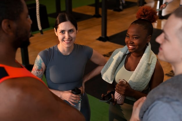 A diverse group of people participating in a group fitness class at a local gym, with a motivational instructor leading the session.