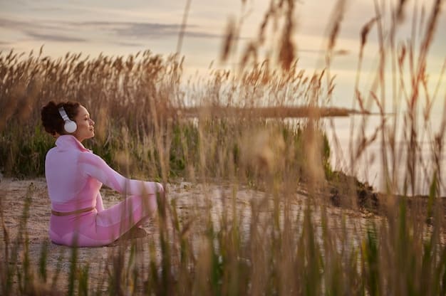 A person meditating in a peaceful outdoor setting at sunrise, deep breathing exercises and mindfulness.