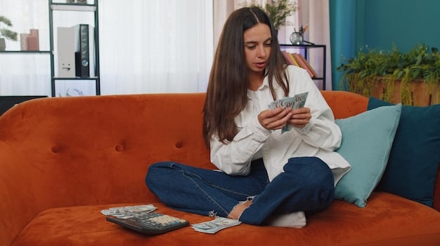 A person using a budgeting app on their phone while sitting on a couch, showcasing practical money management.