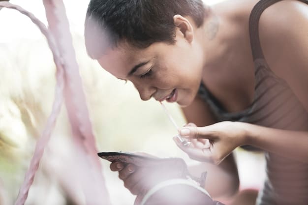 A person using a meditation app on their smartphone. The app displays a timer and guided meditation instructions. The person is seated in a comfortable chair with their eyes closed, focusing on the screen.