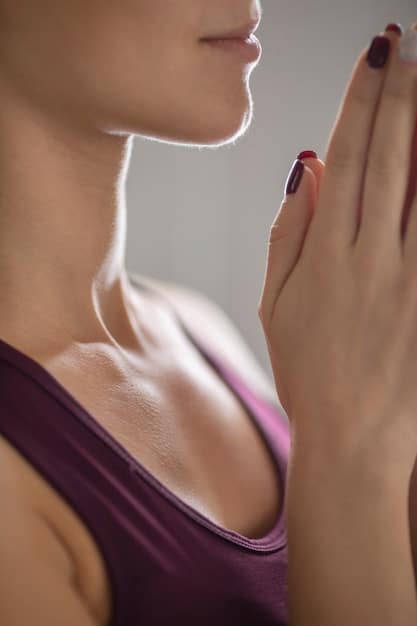 A close-up shot of a person's hands gently folded in a meditation posture, with soft natural light illuminating their serene expression, emphasizing the importance of mindfulness and inner peace in Zen practice.
