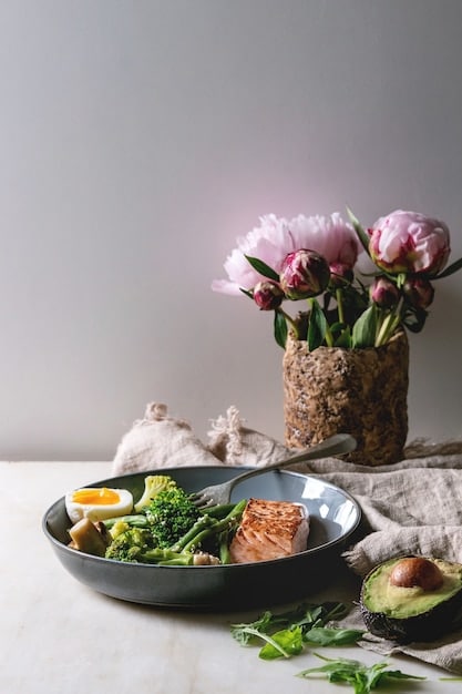 A balanced dinner plate with foods known to promote sleep, such as salmon, almonds, chamomile tea, and kiwi, placed on a wooden table in a softly lit setting.