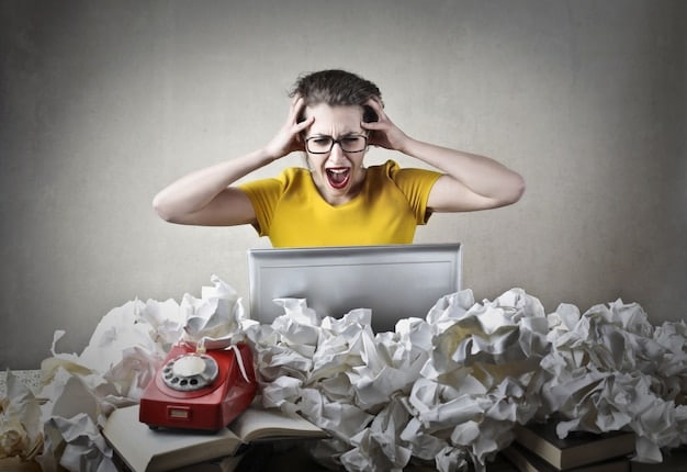 A person looking overwhelmed at their cluttered desk, surrounded by stacks of papers and a ringing phone, illustrating workplace stress.
