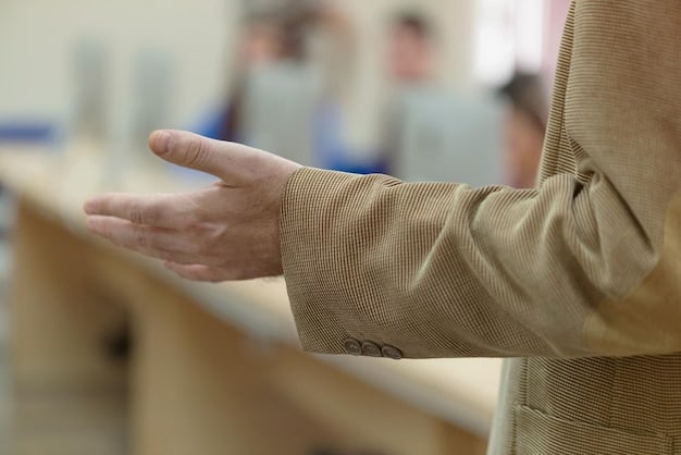 A close-up of a person's hands performing wrist rotations at a desk. The hands are gently moving in a circular motion. The background is slightly blurred to focus on the hand movements.