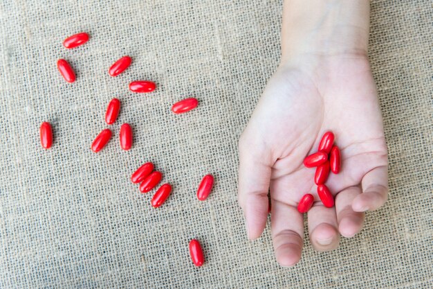 A person holding a capsule of ashwagandha supplement, with a focus on the texture and quality of the capsule. The background should be blurred to emphasize the supplement.