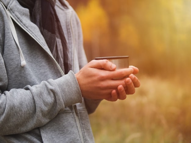A hand reaching to buy an item online, but pausing mid-click, symbolizing mindful consideration before purchase. The background is blurred, focusing attention on the hand and the moment of decision.
