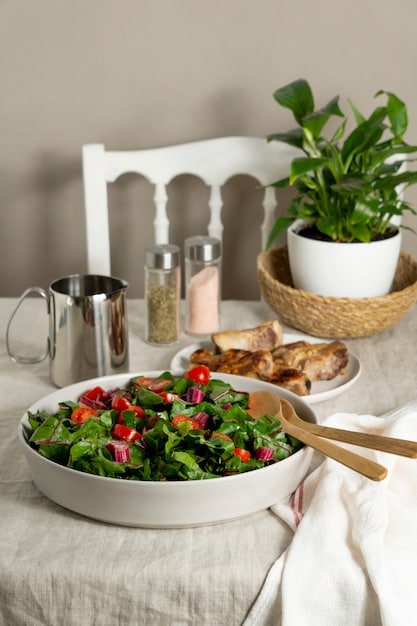 A table setting with a single, colorful salad, emphasizing mindful eating and appreciating healthy, simple meals. Soft, natural lighting highlights the fresh ingredients.