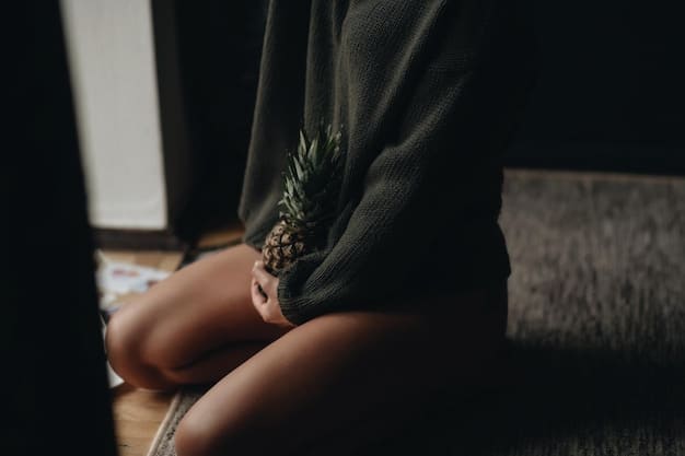 A close-up of a person's hands gently resting on their knees while meditating. The background is blurred, with soft natural light filtering through leaves, creating a sense of calm and focus on the present moment.