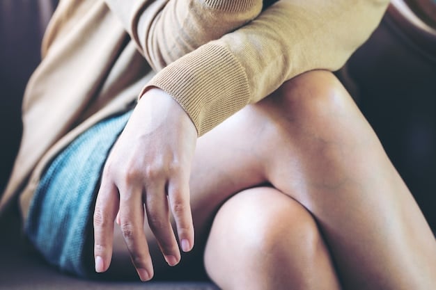 A close-up shot of a person's hands gently pressing down on their thighs in a seated forward fold, emphasizing the spine's curvature and the deep stretch in the hamstrings. The background is blurred to focus on the posture and stretch.