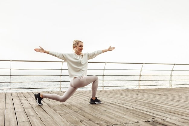 A person doing a low lunge with their arms raised overhead, showcasing good hip flexibility and posture. Focus on the alignment of the spine and the stretch in the hip flexors. The background is a bright, minimalist studio.