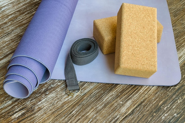 A variety of eco-friendly yoga mats made from different materials like natural rubber, cork, and TPE, displayed in a yoga studio or retail setting, highlighting the range of sustainable choices available.