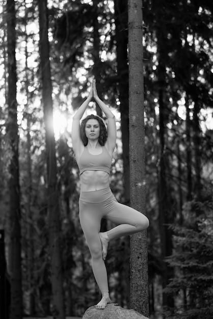 A woman gracefully transitioning between yoga poses in a Vinyasa flow, demonstrating the fluidity and synchronicity of movement and breath.
