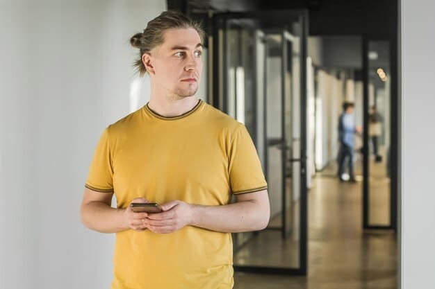 A close-up of a person holding their stomach in discomfort, with a blurred background showing a stressful office environment.