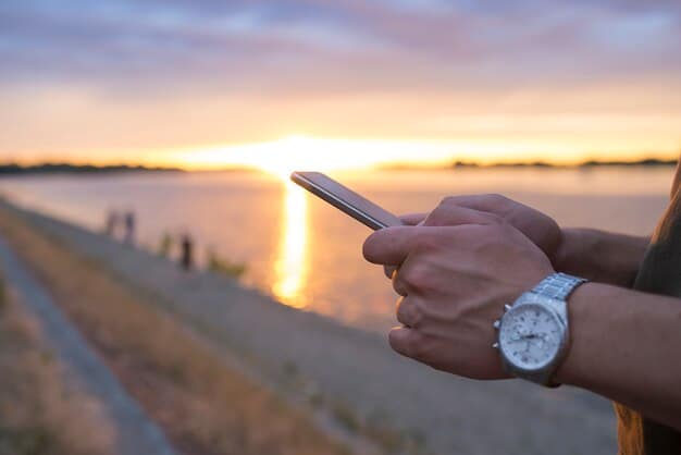 A person setting a timer on their phone to limit their news app usage, with a peaceful nature scene in the background.