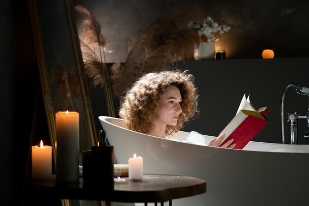 A person taking a warm bath with aromatherapy candles lit around the bathtub, creating a peaceful and serene atmosphere. The scene should emphasize relaxation and self-care before bedtime.