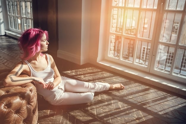 A person sitting in a comfortable chair, eyes closed, meditating with soft light filtering through a window, representing introspection and self-awareness in identifying limiting beliefs.