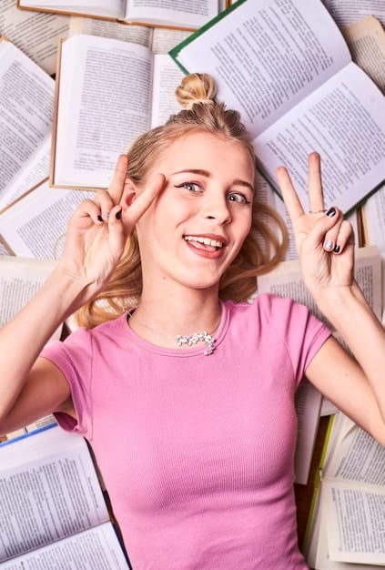 A young woman smiling confidently while studying a complex equation, showcasing dedication to learning and improvement. She's surrounded by books and notes, indicating a consistent effort.