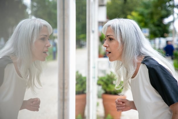 A person looks in the mirror and sees in their reflection an old and frustrated version of themselves.