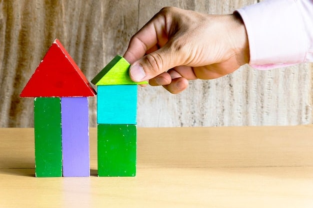 A close-up of a hand building a tower with colorful building blocks on a wooden table. The image highlights creative construction and problem-solving skills.