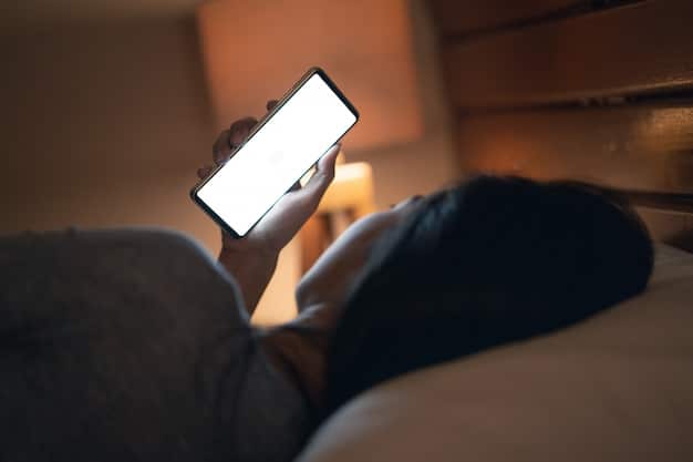 A person using a sleep tracking app on their smartphone in bed, with a focus on the screen displaying sleep metrics. The room is dimly lit to reflect a nighttime setting.