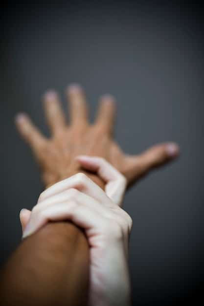 Two hands reaching out to each other over a gap, symbolizing empathy and reconciliation. The background is blurred to focus attention on the hands.