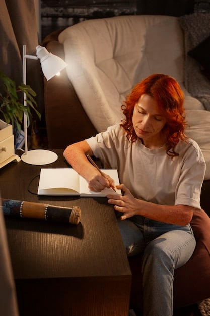 A person sitting in a comfortable chair, eyes closed, with light shining on them, symbolizing introspection and self-reflection. A notebook and pen are nearby.