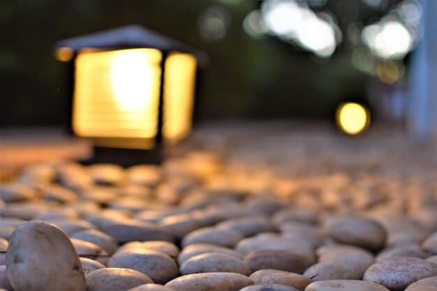 A handmade stone lantern illuminating a zen garden at dusk, casting a warm glow on the carefully raked gravel.