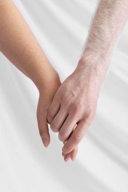 Close-up shot of two people holding hands with a gentle touch, emphasizing the act of listening with empathy and compassion. The background is soft and out of focus, highlighting the intimate connection between them.