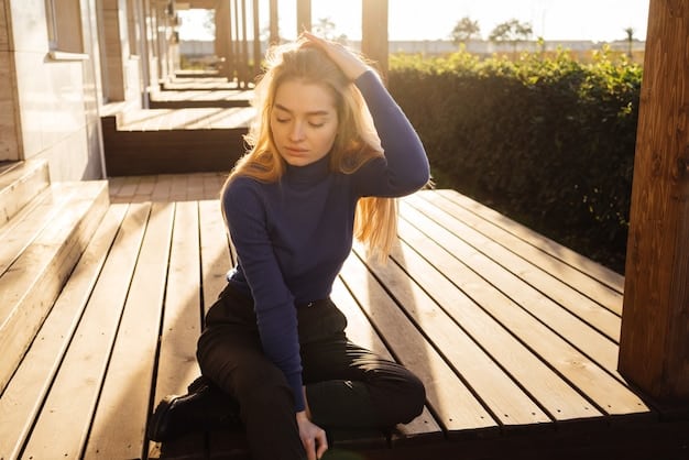 A person sitting on a park bench, face turned towards the sun, eyes closed, with a gentle breeze ruffling their hair.