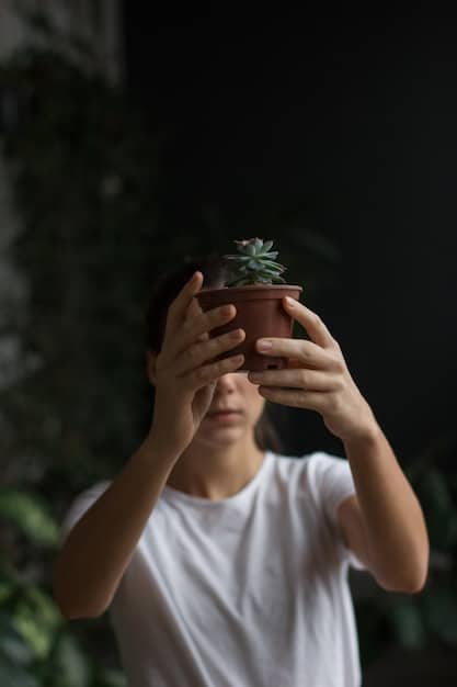 A close-up shot of a person's hands mindfully watering a small potted plant in a minimalist setting. Focus on the act of nurturing and the quiet satisfaction it brings.