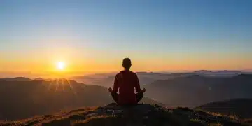 Person meditating at sunrise, symbolizing resilience and mental strength