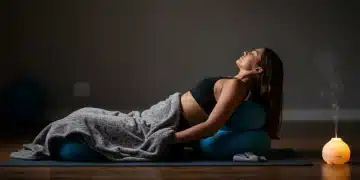 Woman practicing restorative yoga for improved sleep and recovery by 2026.