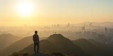 Person on mountain overlooking city, symbolizing emotional resilience and future readiness